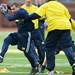 Former Michigan football player Jason Eldridge attempts to slip through defense during the annual alumni flag football game before spring practice at Michigan Stadium on Saturday, April 13, 2013. Melanie Maxwell I AnnArbor.com